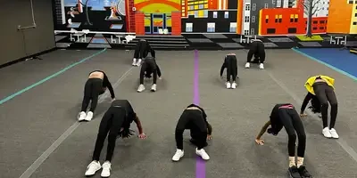 Young cheerleaders stretching in the EPIC Cheer & Dance Academy gym